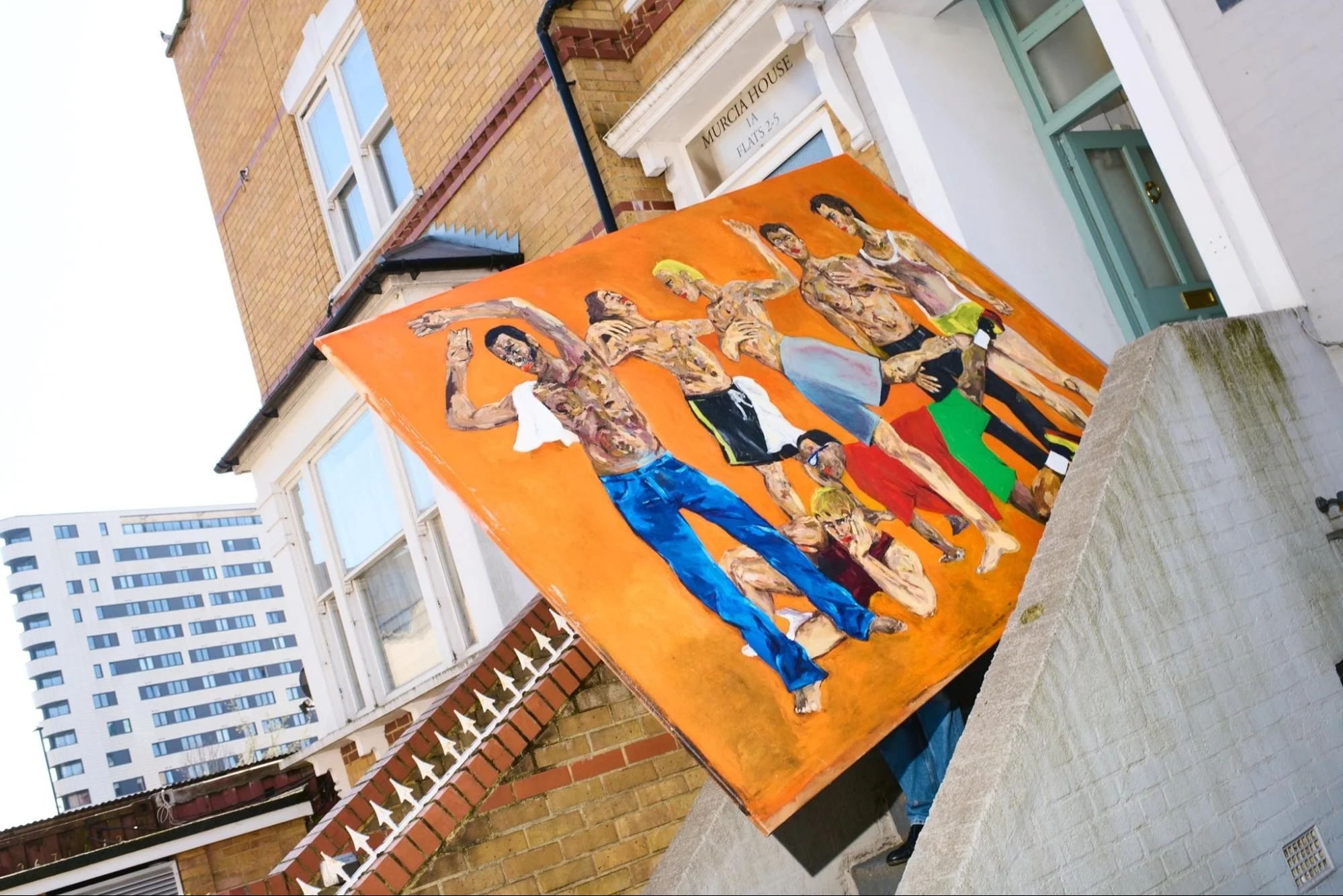 Oversized abstract orange canvas painting handled by contemporary art handlers during a luxury gallery transit setup.