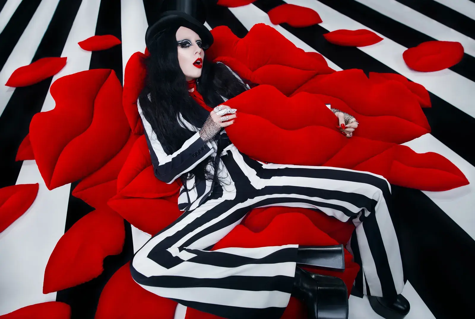 B. Åkerlund captured for Ikea in a striped suit surrounded by bold red lips.