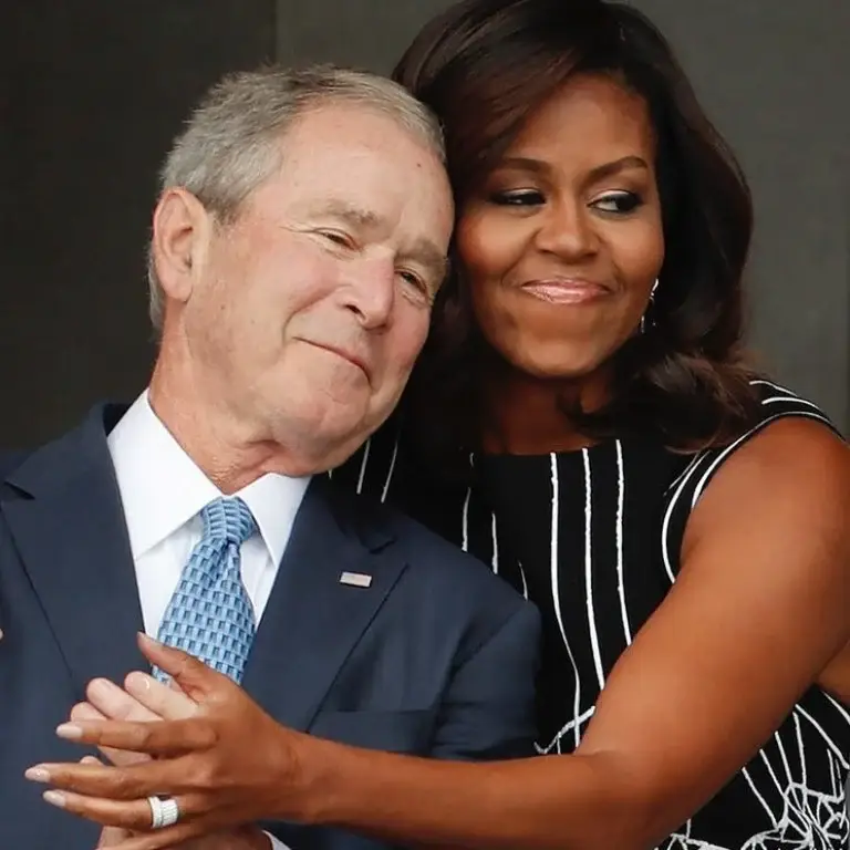 Michelle Obama and George W. Bush embracing.
