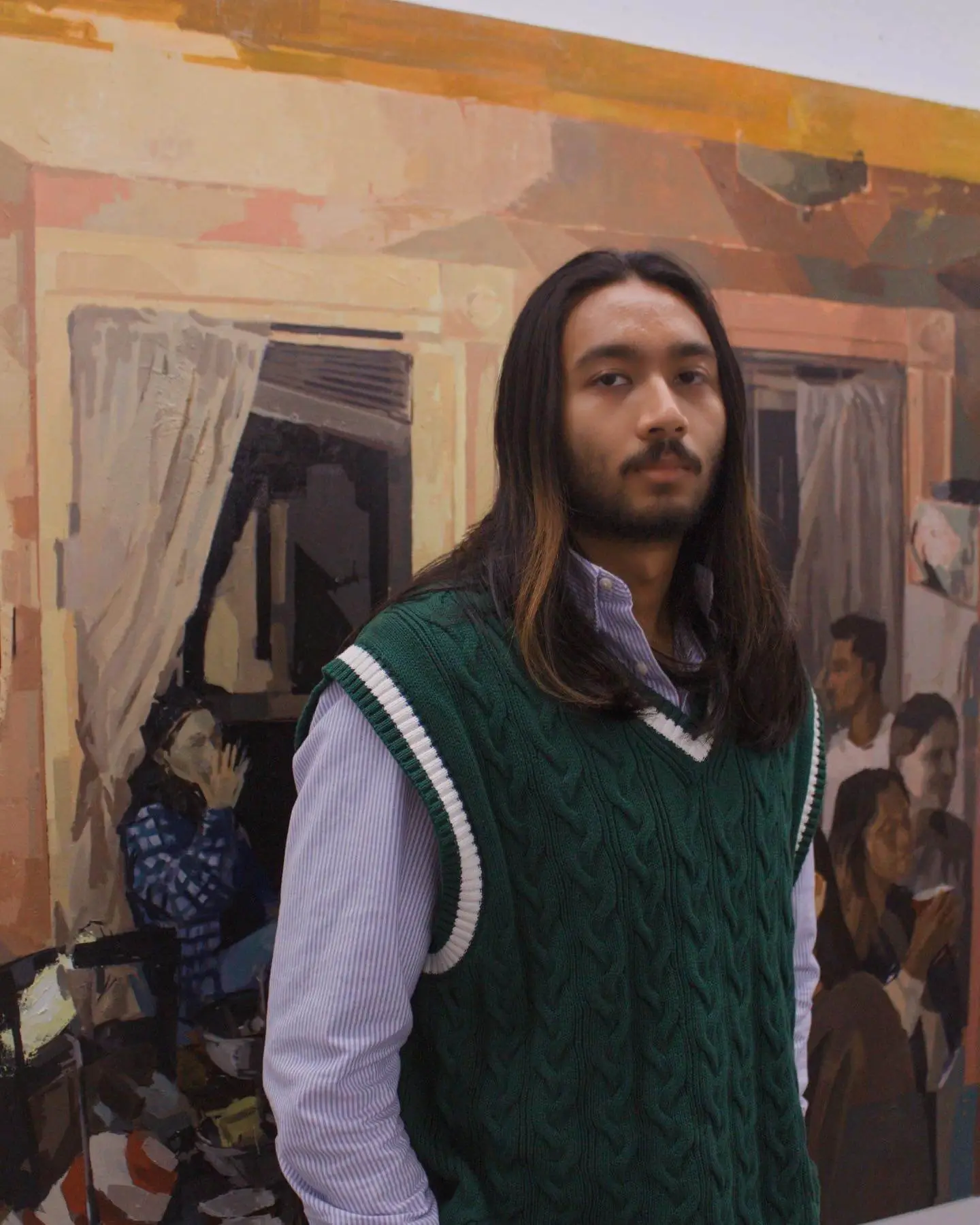 Ricky Vasan with some of his paintings
